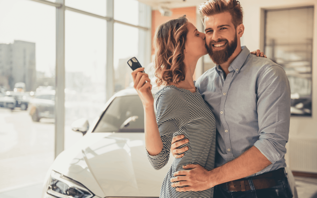 A man and woman excited to purchase a new car