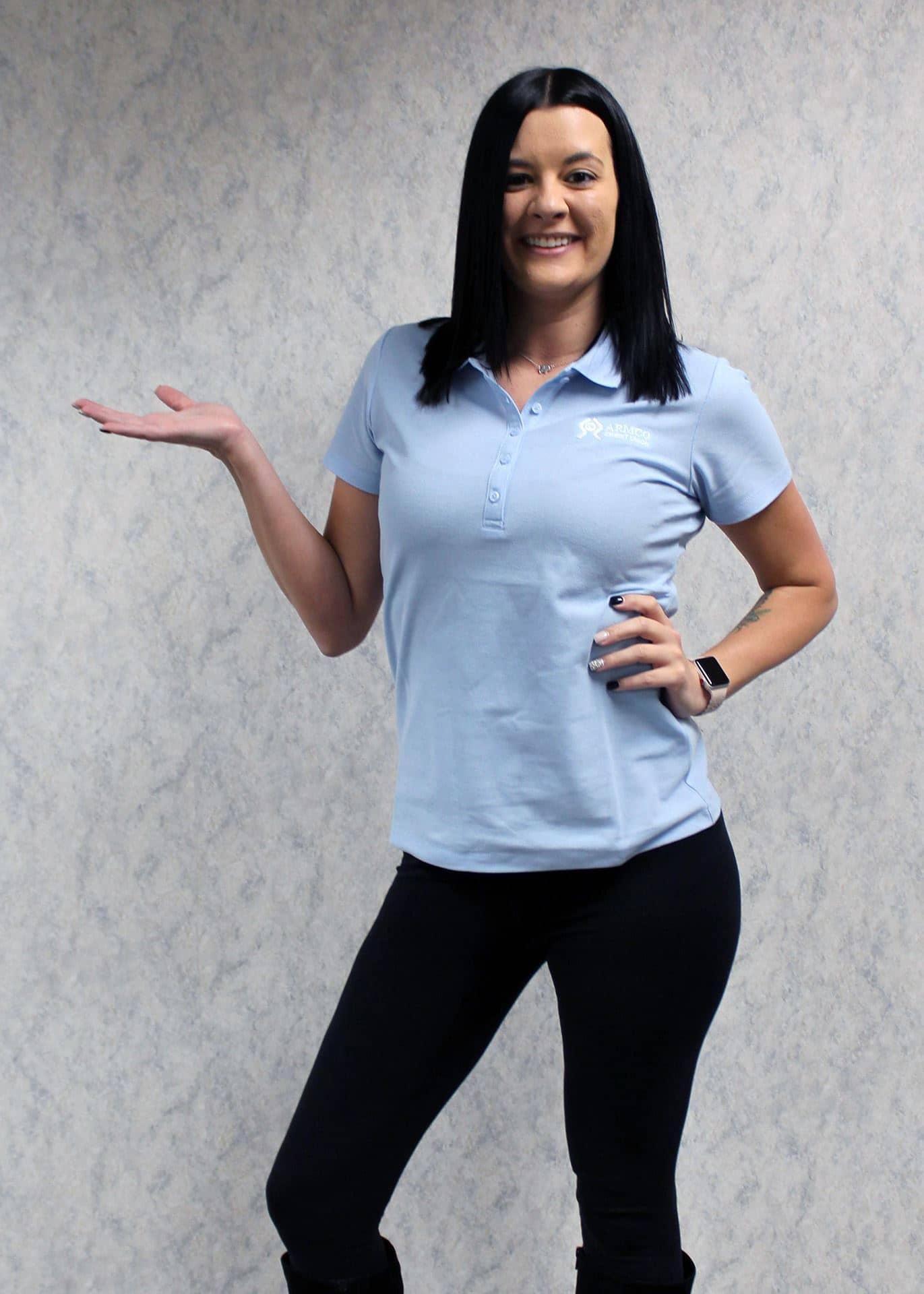 A woman wearing the light blue Armco CU polo shirt.